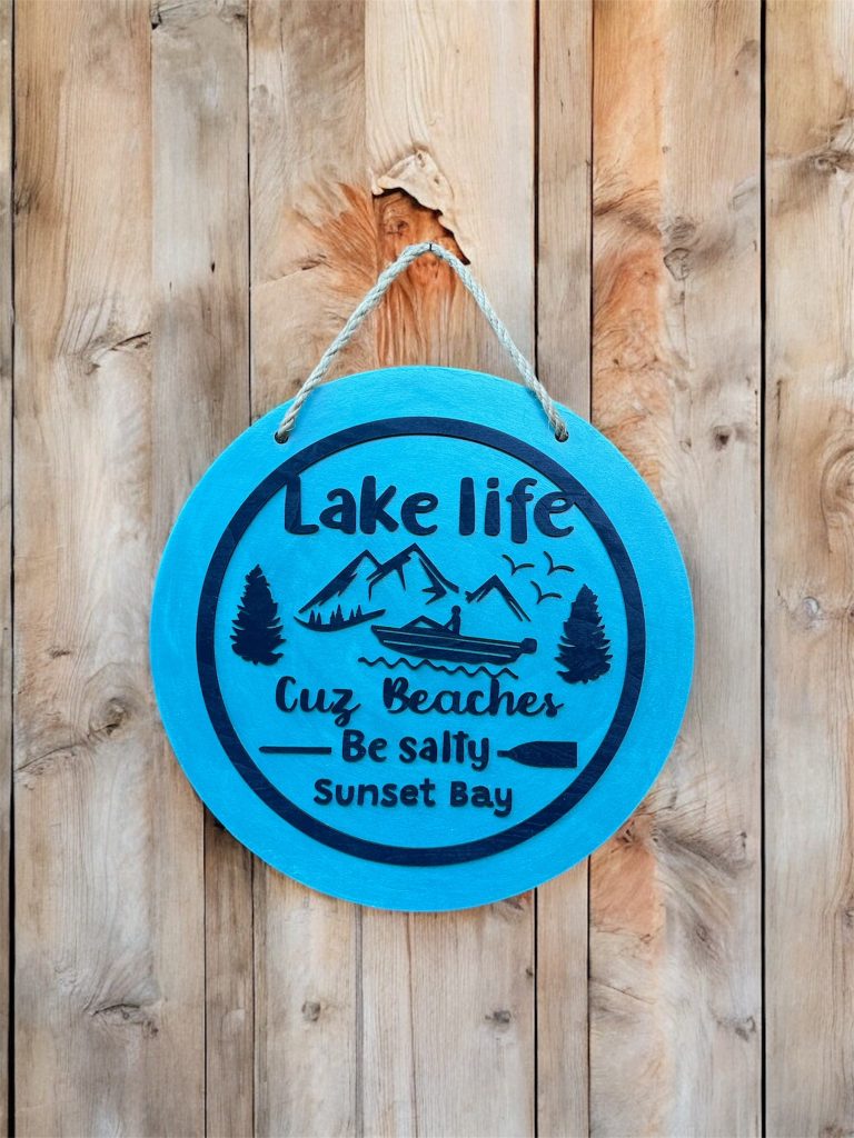 Lake Life Sign 14" Round with mountains and words Lake Life Cuz Beaches be Salty written in navy blue Customized text Sunset Bay.