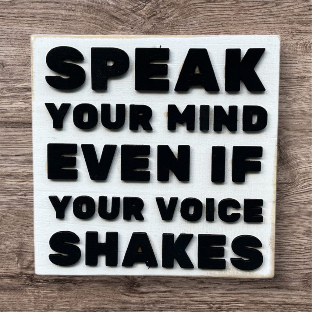 Speak your mind even if your voice shakes white sign with black letters. Available at NorthwestWanderWorks.etsy.com